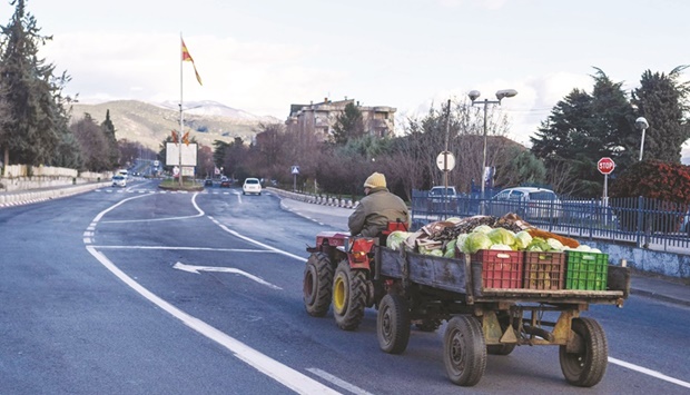 A farmer returns from the fields with his tractor last month in the North Macedonian town of Valandovo, where young people are fleeing in large numbers hoping to find a better life abroad. (AFP)