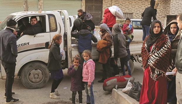 Syrians flee their homes in the Ghwayran neighbourhood in the northern city of Hasakeh, yesterday, on the fourth day of fighting between the Kurdish forces and Islamic State (IS) group fighters.