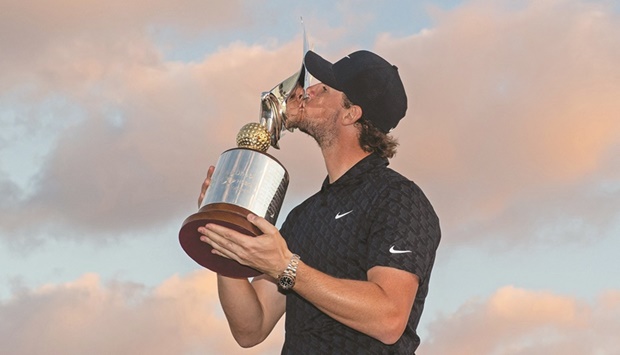 Thomas Pieters of Belgium celebrates with the trophy after winning the Abu Dhabi HSBC  Championship at Yas Links Golf Course yesterday. (AFP)