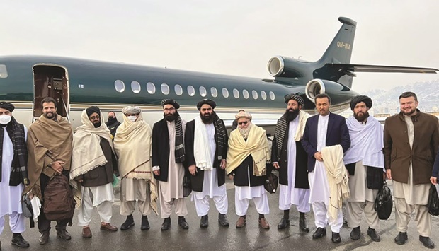 This handout photograph released by the Afghan Taliban shows Foreign Minister Amir Khan Muttaqi (centre), senior official member Anas Haqqani (right) and delegates posing for pictures before departing to Oslo, at the Kabul airport in Kabul. (AFP)