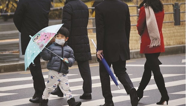 A boy wearing a mask walks on a zebra crossing in Seoul, South Korea on Tuesday. The BoK expects GDP to grow 3.0% this year as Asiau2019s fourth-largest economy benefits from strength in semiconductor exports and increased public spending, though record domestic Covid-19 cases this week are a threat to consumption.