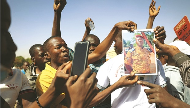Demonstrators gathering in Ouagadougou to show support to the military hold a picture of Lieutenant Colonel Paul-Henri Sandaogo Damiba the leader of the mutiny and of the Patriotic Movement for Preservation and Restoration (MPSR).