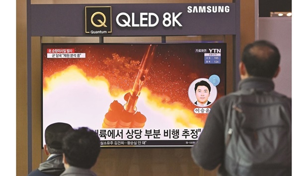 People watch a television screen showing a news broadcast with file footage of a North Korean missile test, at a railway station in Seoul yesterday after North Korea fired two suspected cruise missiles according to the Southu2019s military.