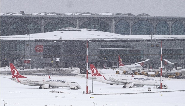 Aircraft parked on the tarmac of Istanbul airport, where flights were cancelled due to blizzard and heavy snowfall, in Istanbul yesterday. (AFP)