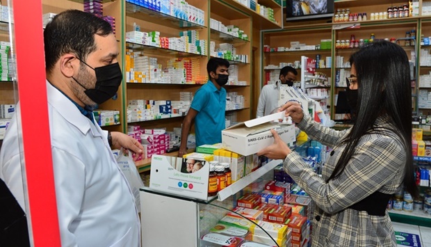 A pharmacy employee explaining how to use a RAT kit to a customer. PICTURES: Shaji Kayamkulam