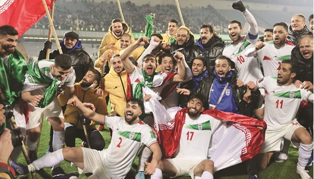 Iran players celebrate after qualifying for the FIFA World Cup Qatar 2022 after their win over Iraq in the Asian Qualifiers match at the Azadi Sports Complex in Tehran yesterday. (AFP)