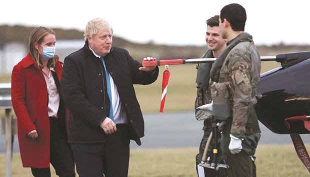 Britainu2019s Prime Minister Boris Johnson speaks with pilots during a visit to RAF Valley, the Royal Air Force station on the island of Anglesey in north Wales, yesterday.