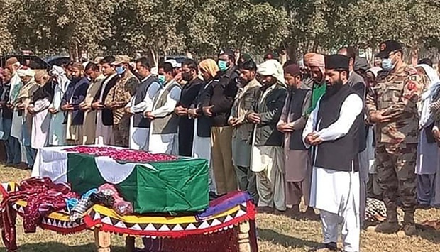 Military officials and local residents offer funeral prayers for a soldier who was killed in an attack in the Kech district of Balochistan province, in Dera Murad Jamali on  January 27. AFP