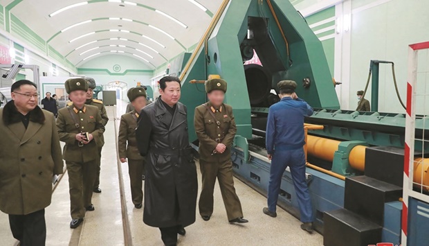 North Korean leader Kim Jong-un inspecting a munitions factory producing a major weapon system at an undisclosed location.