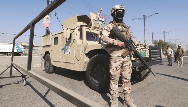 Iraqi soldiers man a checkpoint in the the capital Baghdad yesterday, following a reported rocket attack on the countryu2019s airport.
