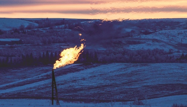 A gas flare on an oil well pad burns as the sun sets outside Watford City, North Dakota (file). US shale producers have transformed from insurgents, disruptors and revolutionaries into incumbents focused on limiting output growth, enjoying higher prices and maximising the return of cash to shareholders.