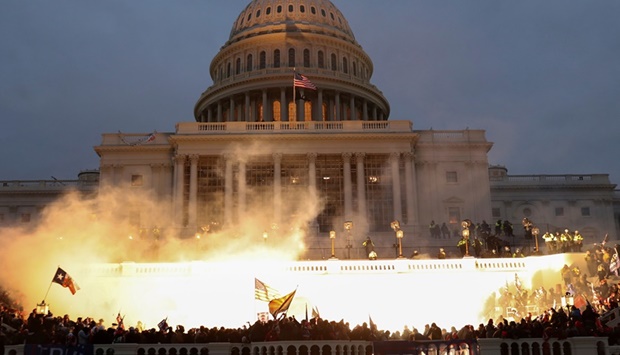 An explosion caused by a police munition while supporters of the-then US president Donald Trump gathered in front of the US Capitol Building in Washington on January 6 last year. (Reuters)