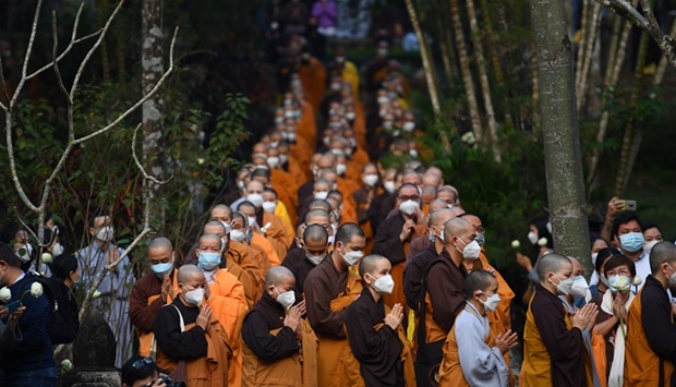 Buddhist monks walk and pray during the procession to a cremation ground for Vietnamese monk Thich Nhat Hanh at Tu Hieu pagoda in Hue province on January 29, 2022