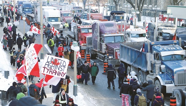 Trucks sit parked on Wellington Street near the parliament buildings in Ottawa as truckers and their supporters take part in a convoy to protest coronavirus vaccine mandates for cross-border truck drivers.
