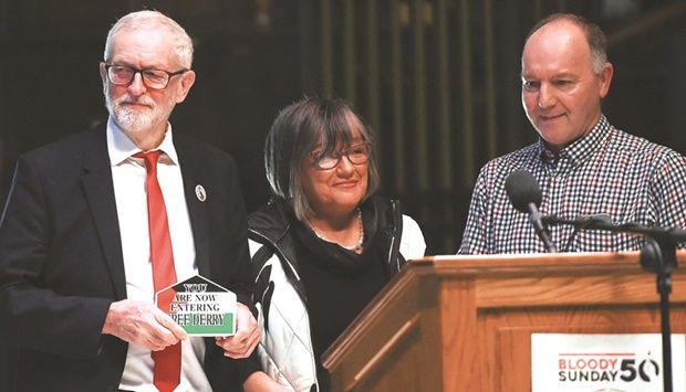 Former leader of Britainu2019s Labour Party Jeremy Corbyn is presented with a plaque by Tony Doherty, son of Patrick Doherty, whose father was shot and killed during the events of u201cBloody Sundayu201d, on the 50th anniversary of shootings in Northern Ireland at the Guildhall in Londonderry, Northern Ireland.