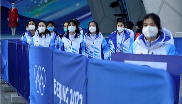 A group of volunteers watch during a rehearsal of the medals ceremony inside the Medals Plaza in Beijing on January 29, ahead of the 2022 Beijing Winter Olympic Games. AFP