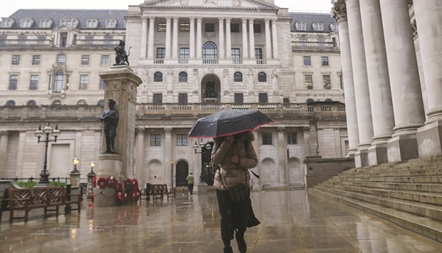 A pedestrian walks past the Bank of England in the City of London. The BoE looks like a trailblazer on the road to tightening policy after the pandemic, even as the European Central Bank makes the case for a very slow normalisation.