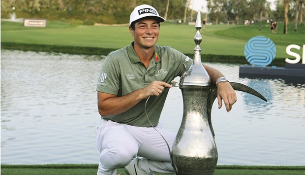 Viktor Hovland of Norway poses with his trophy after winning the Dubai Desert  Classic 2022 at the Emirates Golf Club in Dubai yesterday. (AFP)