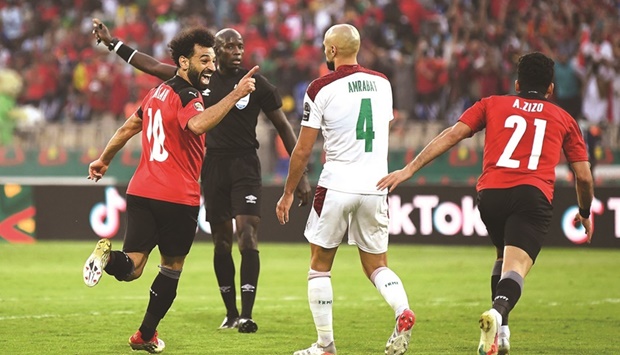 Egyptu2019s forward Mohamed Salah (left) celebrates his second goal during the Africa Cup of Nations quarter-final against Morocco at the Stade Ahmadou Ahidjo in Yaounde yesterday. (AFP)