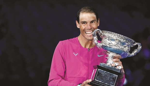 Spainu2019s Rafael Nadal celebrates with the trophy after winning the Australian Open in Melbourne yesterday. (Reuters)