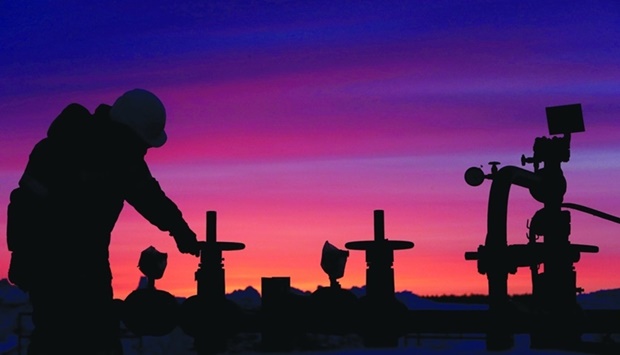 A worker checks the valve of an oil pipe at an oil field owned by Russian state-owned oil producer Bashneft near the village of Nikolo-Berezovka, northwest of Ufa, Bashkortostan, Russia.