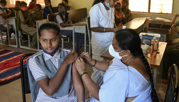 A health worker inoculates a student with a dose of the Covaxin vaccine against the Covid-19 coronavirus during a vaccination drive for people in the 15-18 age group, at the Nelamangala Government High School and Junior College in Bangalore.
