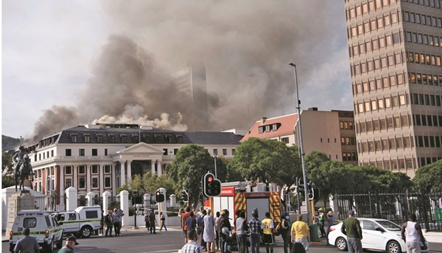 Smoke arises from the National Assembly, the main chamber of the South African Parliament buildings, after a fire that broke out the day before restarted, in Cape Town, yesterday.
