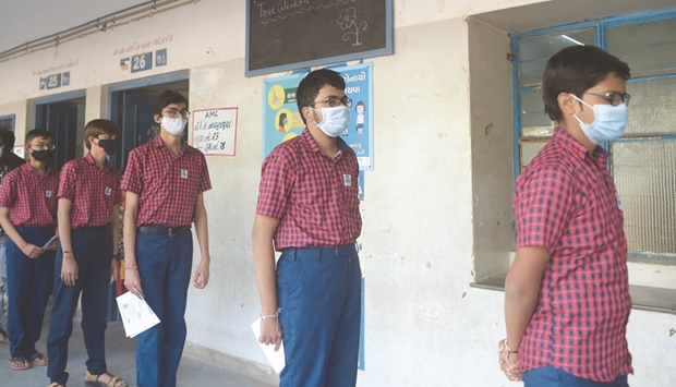 Students wait in line to receive a dose of the Covaxin during a vaccination drive in Ahmedabad.