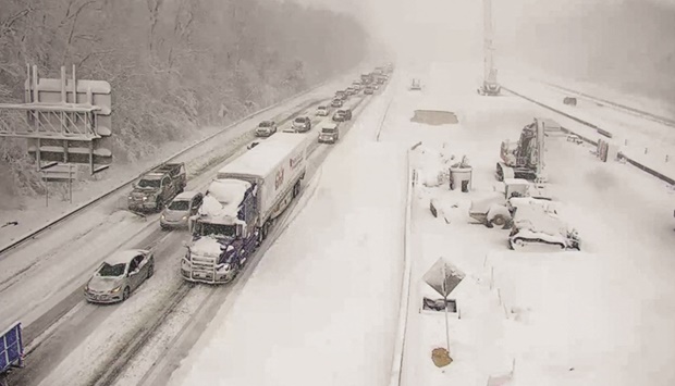 Vehicles are seen on an icy stretch of Interstate 95 as a storm blankets the US region in snow, near Fredericksburg, Virginia.