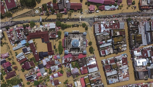 This aerial picture shows inundated buildings including a mosque during flooding in Lhoksukon, North Aceh, yesterday.