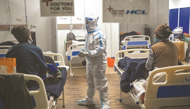 A health worker wearing Personal Protective Equipment (PPE) suit interacts with patients inside a ward at the Commonwealth games (CWG) village sports complex, temporarily converted into Covid-19 coronavirus care centre, in New Delhi yesterday.