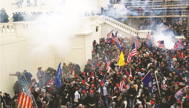 Police release tear gas into a crowd of pro-Trump protesters during clashes at a rally to contest the certification of the 2020 US presidential election results by the Congress, at the US Capitol Building in Washington, on January 6, last year. (Reuters)