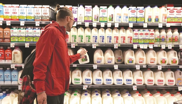A customer takes a gallon of milk for sale at Harmons Grocery store in Salt Lake City, Utah, US. The Food and Agriculture Organisationu2019s (FAO) food price index, which tracks the most globally traded food commodities, averaged 125.7 points in 2021, the highest since 131.9 in 2011.