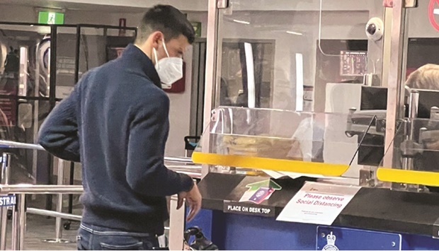 Serbian tennis player Novak Djokovic stands at a booth of the Australian Border Force at the airport in Melbourne, Australia, on Wednesday. (Reuters)