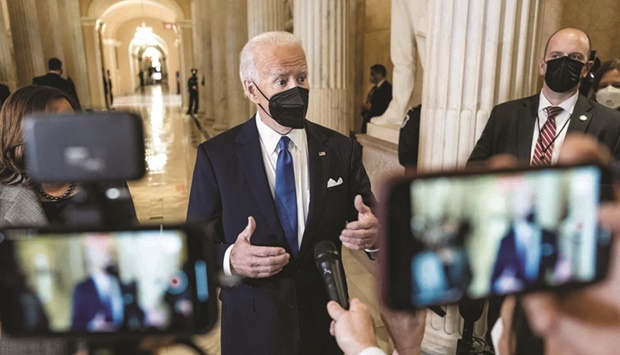 US President Biden speaks to reporters in the Hall of Columns on the one-year anniversary of the January 6, 2021 attack on the Capitol.
