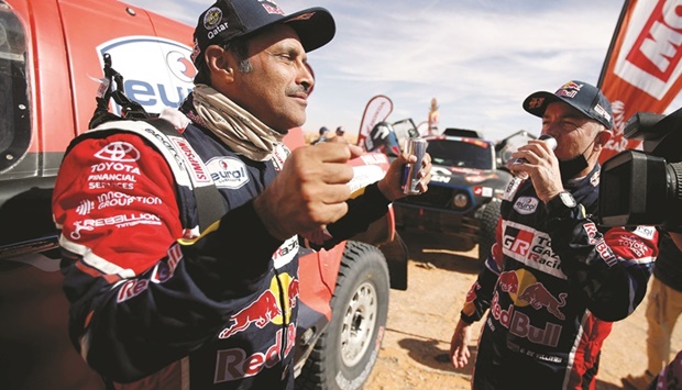 Qataru2019s Nasser al-Attiyah (left) after the end of stage six at Dakar Rally. (Reuters)
