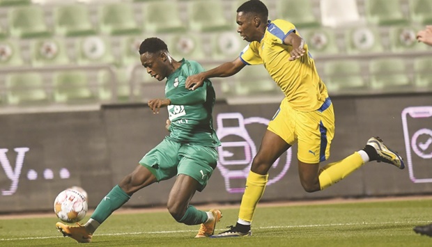 Al Gharafa (in yellow) and Al Ahli players vie for the ball at the Hamad Bin Khalifa Stadium yesterday. PICTURE: Shemeer Rasheed