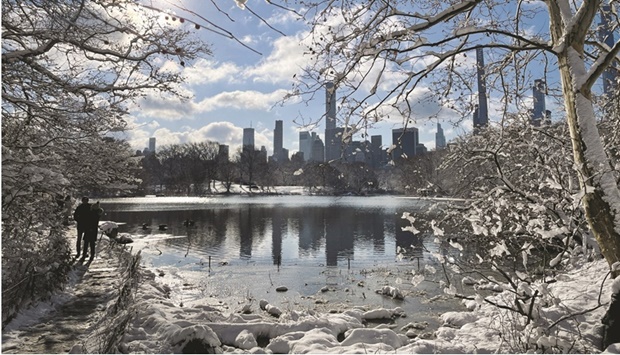 People walk in newly fallen snow in New Yorku2019s Central Park after a winter storm dropped several inches of snow.