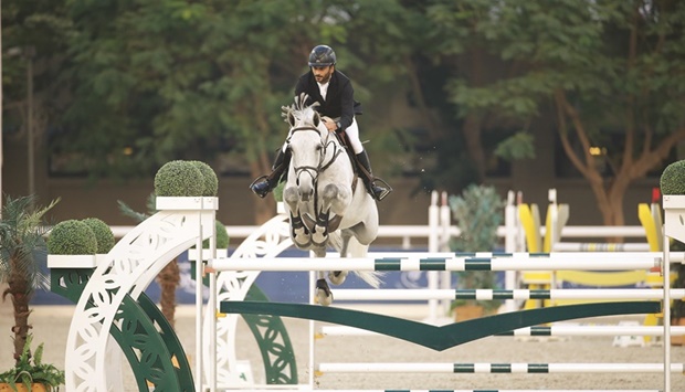 Abdullah Ali al-Ajeil astride 10-year-old grey mare La Corona 10  clears a hurdle during the Longines Hathab Qatar Equestrian Tour at the Qatar Equestrian Federationu2019s outdoor arena yesterday.