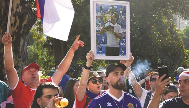 Members of the local Serbian community rally outside a government detention centre where Serbiau2019s tennis star Novak Djokovic is staying in Melbourne yesterday. (AFP)