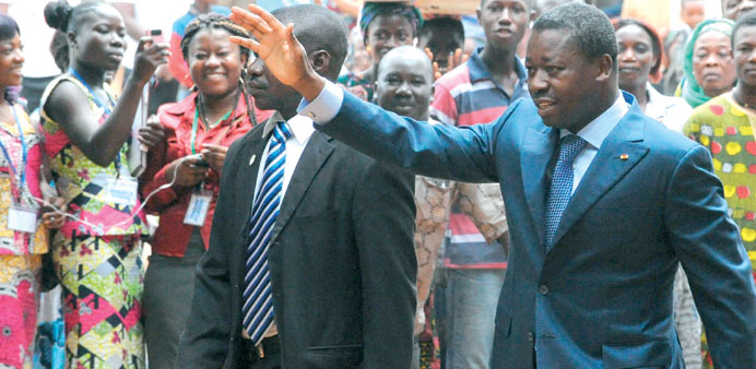 Togolese President Faure Gnassingbe waves to the crowd as he arrives to cast his vote  during the parliamentary election in Lome yesterday.