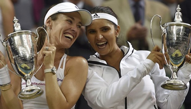 Martina Hingis (L) and Sania  Mirza after winning the Wimbledon doubles crown earlier this year.