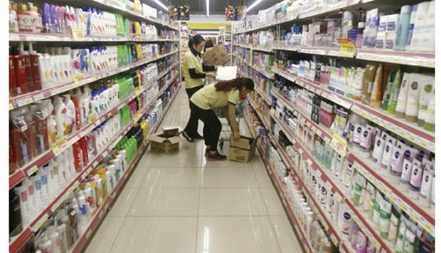 Employees load products onto shelves at a Fivimart supermarket in Hanoi yesterday. Vietnam reported that its economy grew 6.68% in 2015, the fastest pace in five years, helped by an expanding industrial sector and record foreign direct investment.