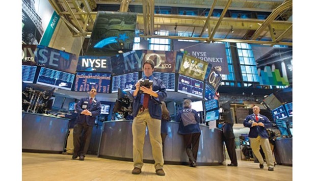 Traders work on the floor of the New York Stock Exchange. As 2015 draws to a close this week, the fortunes of the last few trading days of the year may be dictated by the direction of the financial sector.