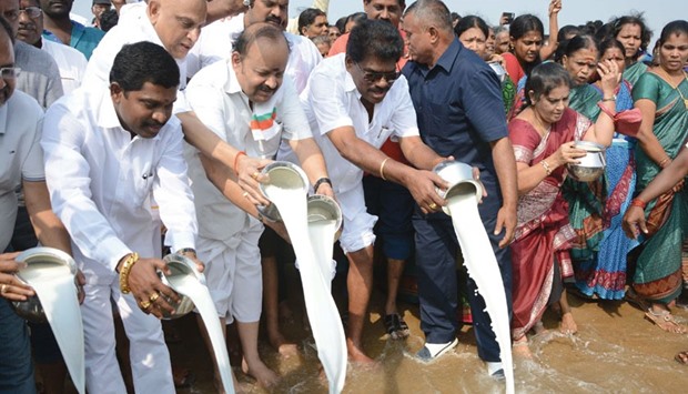 People pour milk into the sea as an offering during a ceremony for the victims of the 2004 earthquake and tsunami at Marina Beach in Chennai yesterday. The earthquake and tsunami which struck the Indian Ocean on December 26, 2004 killed over 230,000 people and devastated coastal communities.
