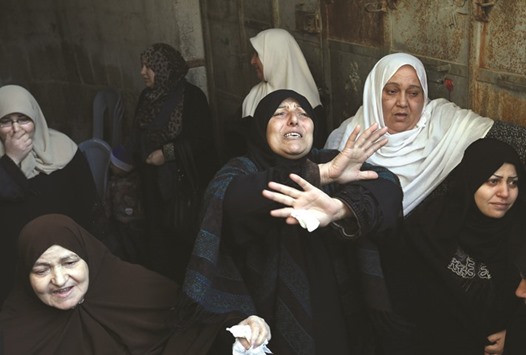 Relatives of 22-year-old Palestinian Hani Wahdan, mourn during his funeral in Gaza City yesterday.