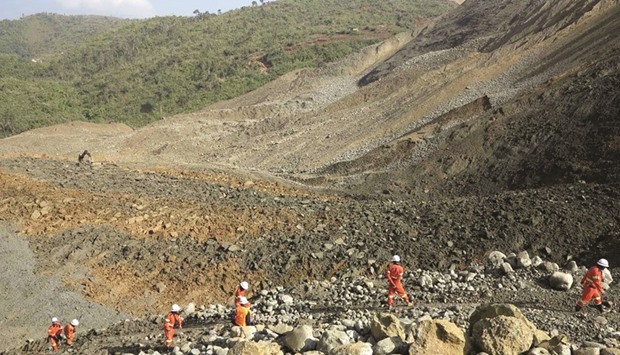 Rescue workers are pictured at the site of a landslide in Hpakant, Kachin State, the war-torn area that is the epicentre of Myanmaru2019s secretive billion dollar jade industry yesterday.