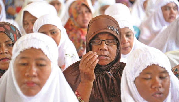 Acehnese women attend a mass prayer gathering at Lampuuk village in Banda Aceh yesterday.