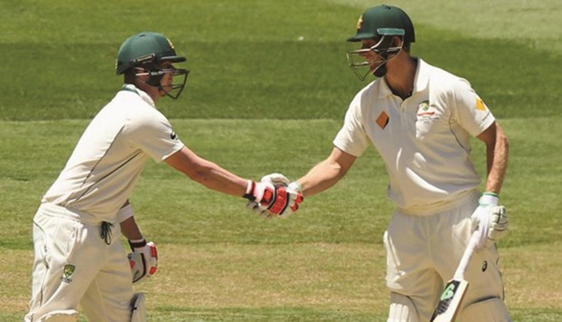 Australiau2019s Adam Voges (right) celebrates his 1000 runs in a calendar year with Steve Smith during day two of the second Test against west Indies in Melbourne yesterday.