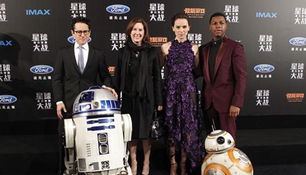 US director J J Abrams, US producer Kathleen Kennedy, British actress Daisy Ridley and British actor John Boyega pose with droid characters BB-8 and R2-D2 on the red carpet during the premiere of Star Wars: The Force Awakens in Shanghai on Sunday.